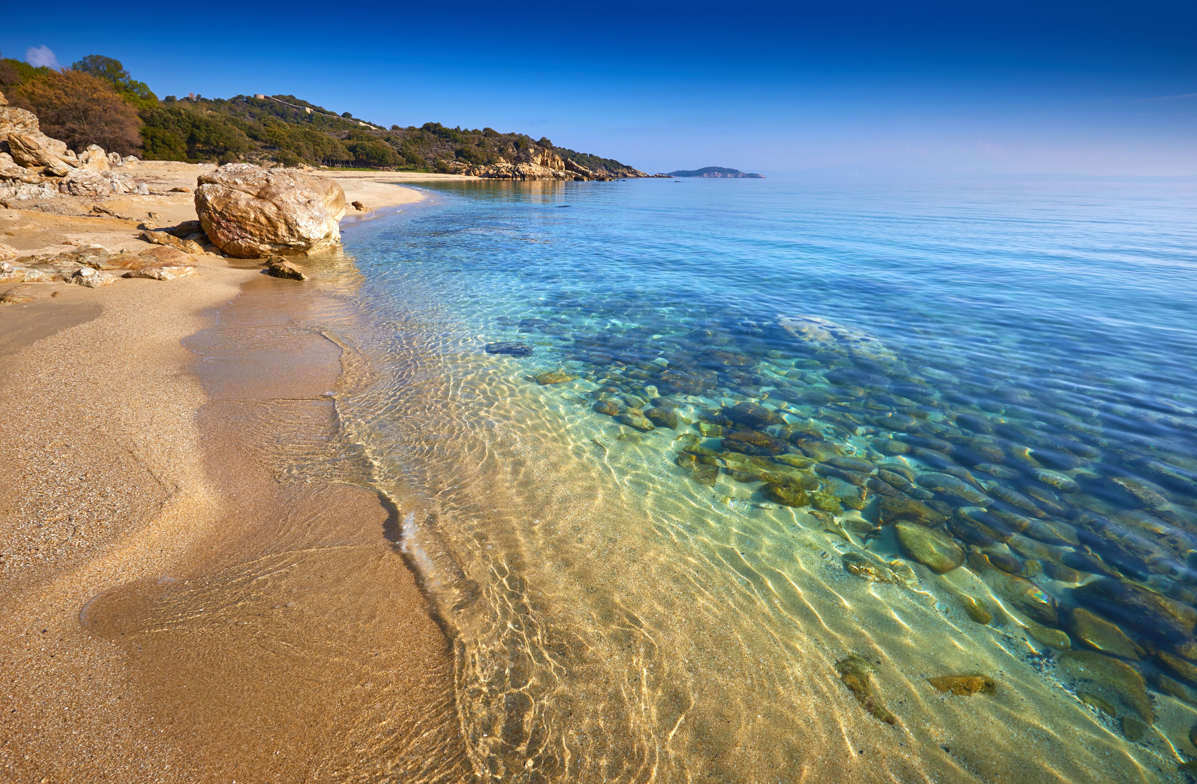 Amazing sunset view on Proti ammoudia beach near Olympiada town summer resort, Kavala region, Greece.. Incredibly romantic sunrise on the beach, Ionian Sea. View of the ocean. Tropical beach