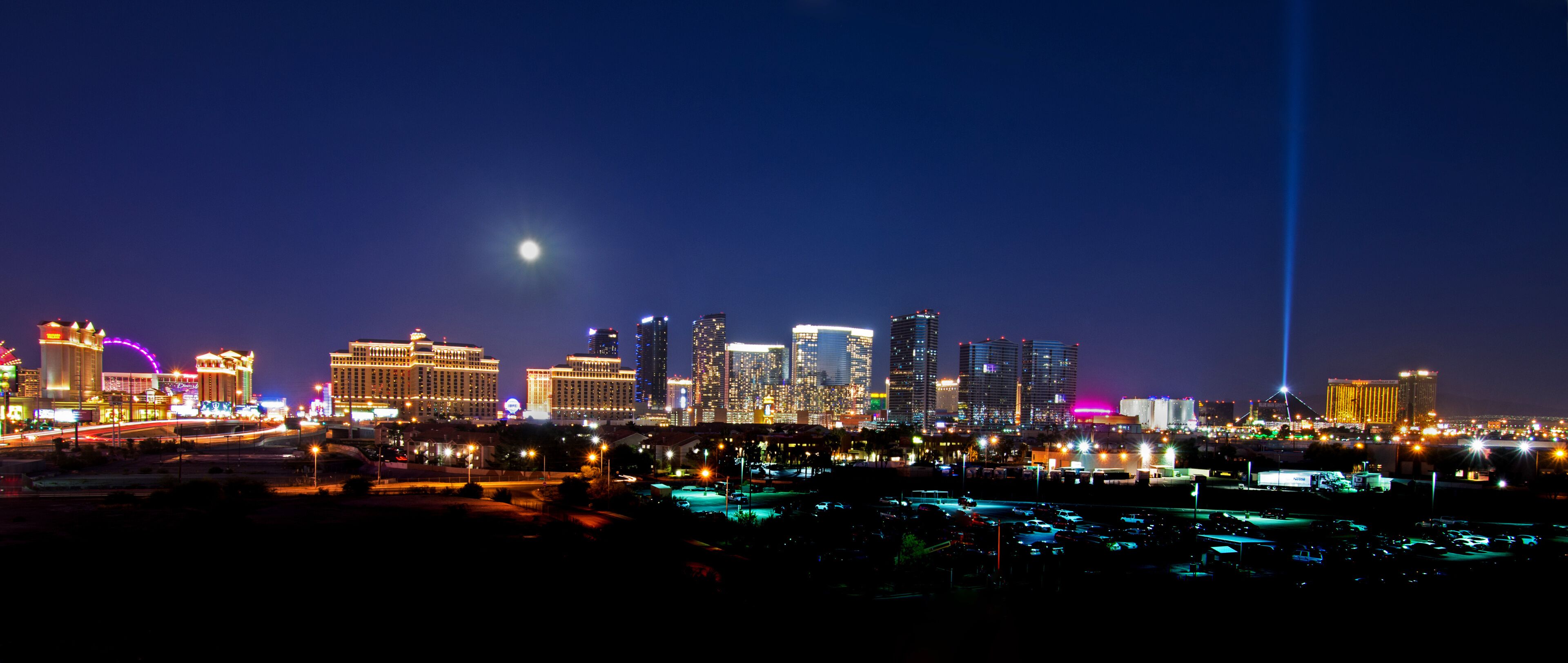 A view of the Las Vegas skyline with a full moon shining down.