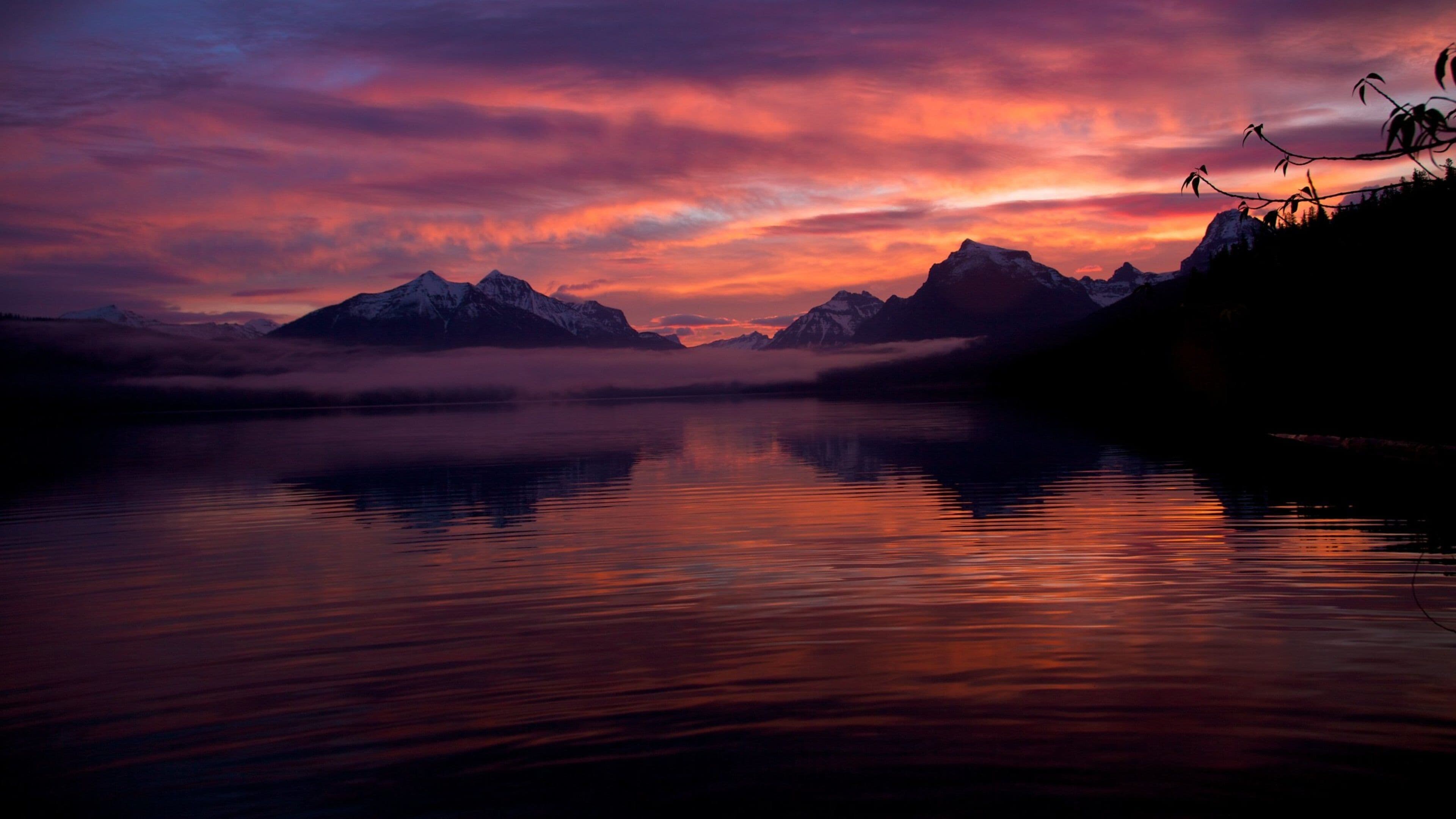 Montana showing mountains, a sunset and a lake or waterhole