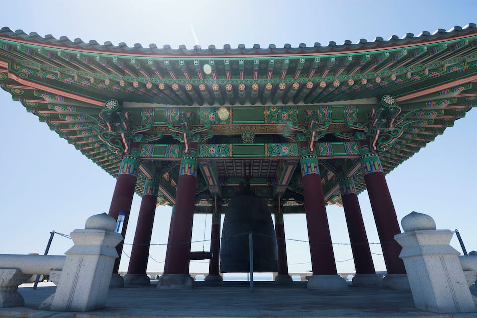 A traditional Korean pavilion with ornate roof and columns.