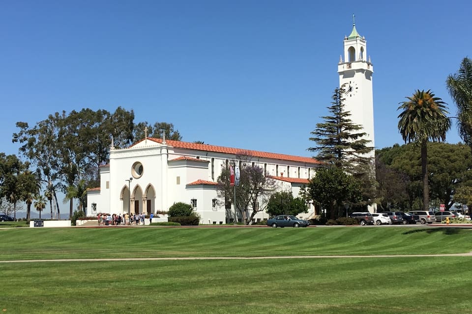 A white church with a bell tower and arched windows.