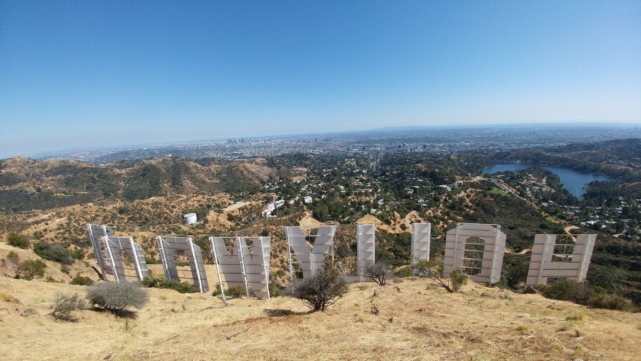 A view of Los Angeles with the Hollywood sign in the foreground.