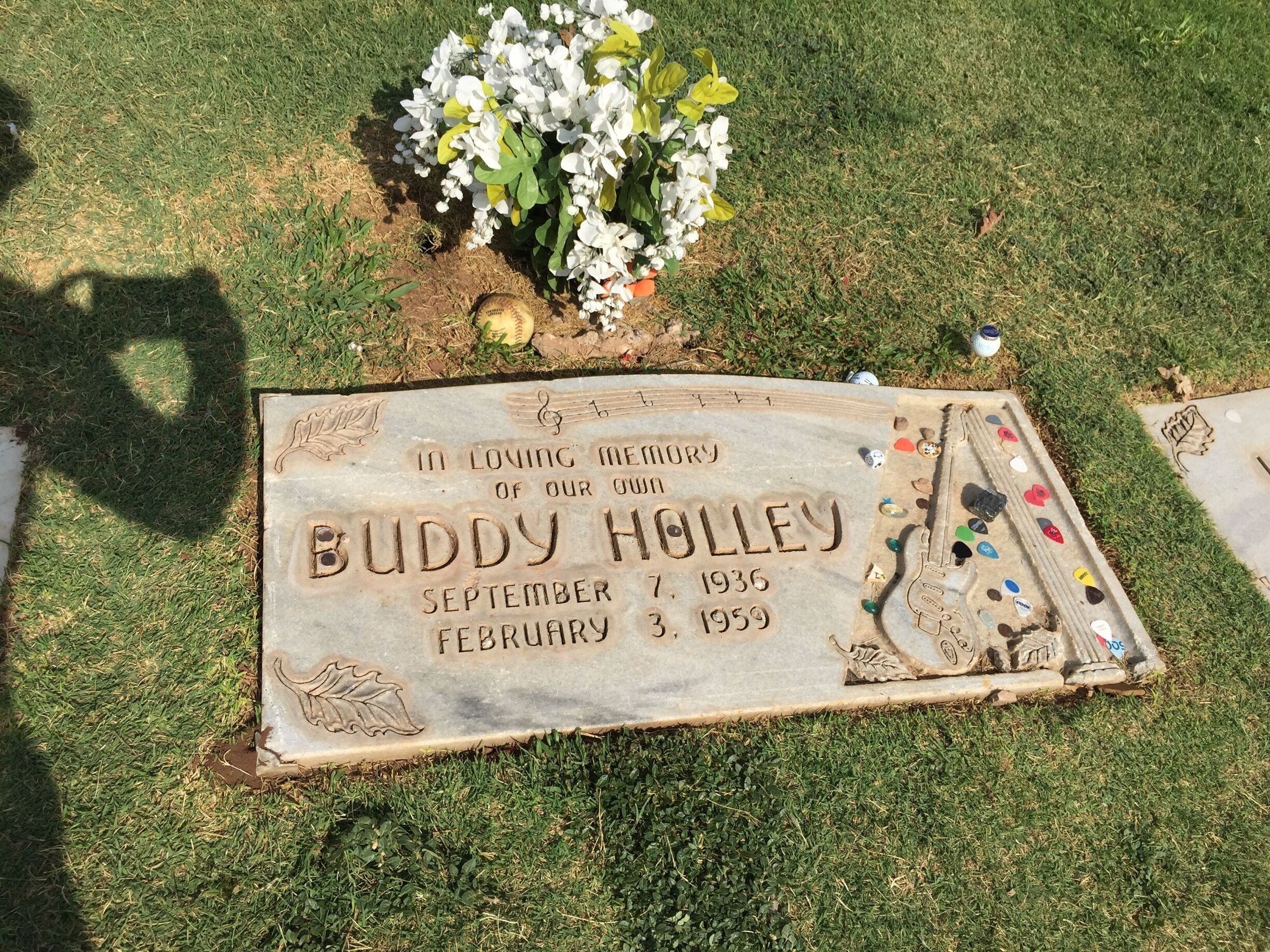 The grave of rock'n' roll icon Buddy Holly, the music lives on. Guitar players leave their picks as a tribute.