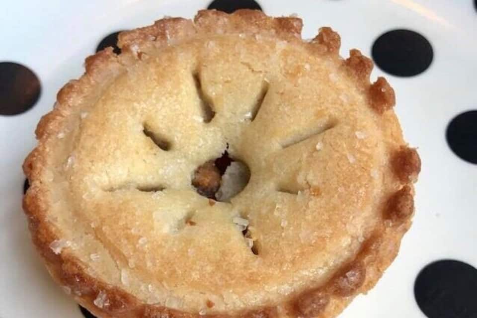 A single pie on a plate with a polka dot pattern.