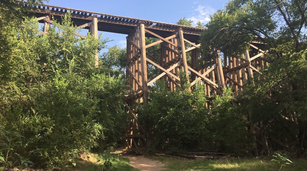 A trail runs under an old railroad bridge on the south end of Dunbar Park. This location is claimed to be a hotspot for paranormal activity and several ghost hunting crews have deemed the location Hell's Gate. Supposedly old western train robbers would dump bodies here, the site has also been notorious for suicides and devil worship. Personally I found it a peaceful trail under an enchanting bridge, of course I never ventured through at night.