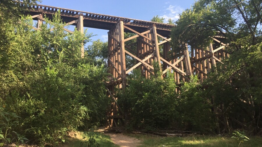 A trail runs under an old railroad bridge on the south end of Dunbar Park. This location is claimed to be a hotspot for paranormal activity and several ghost hunting crews have deemed the location Hell's Gate. Supposedly old western train robbers would dump bodies here, the site has also been notorious for suicides and devil worship. Personally I found it a peaceful trail under an enchanting bridge, of course I never ventured through at night.