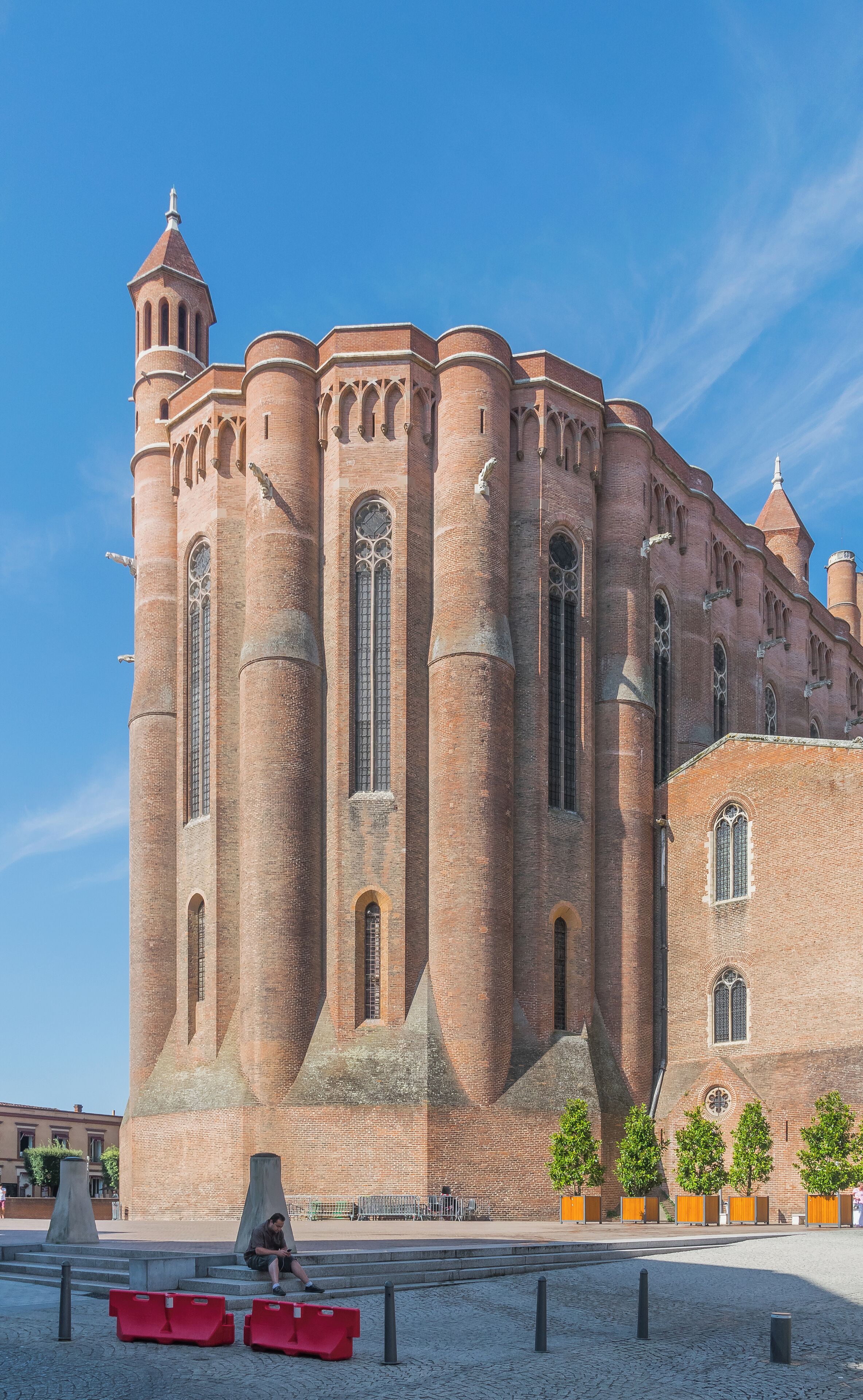 A large brick building with multiple towers and arched windows.