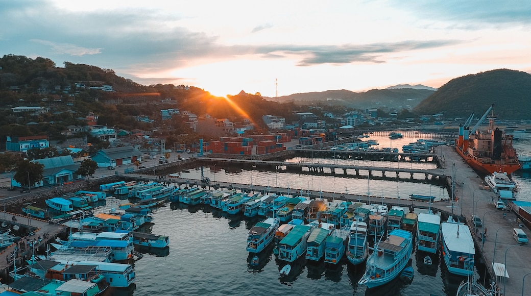 Sunrise at Labuan Bajo Harbour, Flores, Indonesia. Lot of sailing boats for Komodo Dragon trip in Komodo National Park