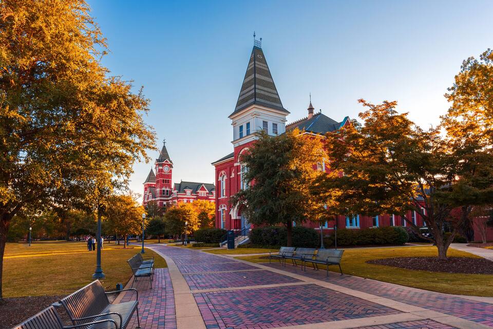 A red brick building with a tower and a clock tower.