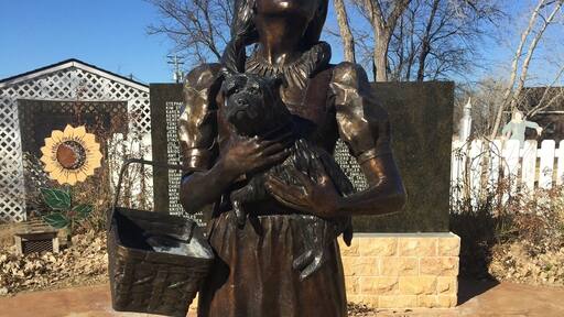 A statue of Dorothy and Toto.