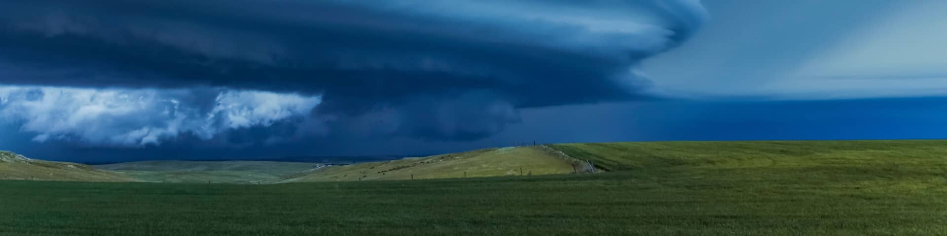 Dramatic dark storm clouds over farmland; Guymon, Oklahoma, United States of America