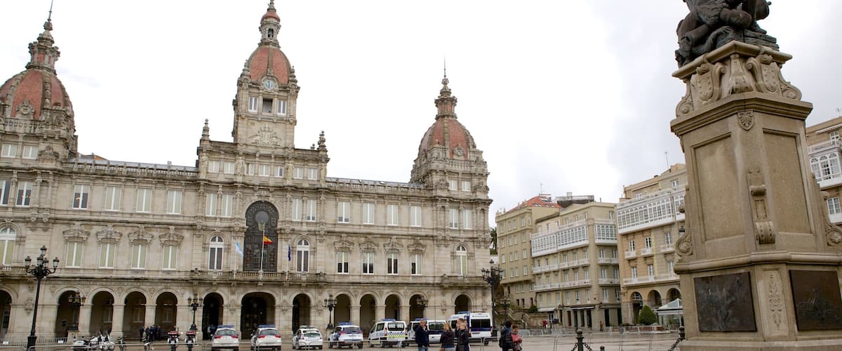 A historic building with ornate architecture, including domed towers and a central clock tower.