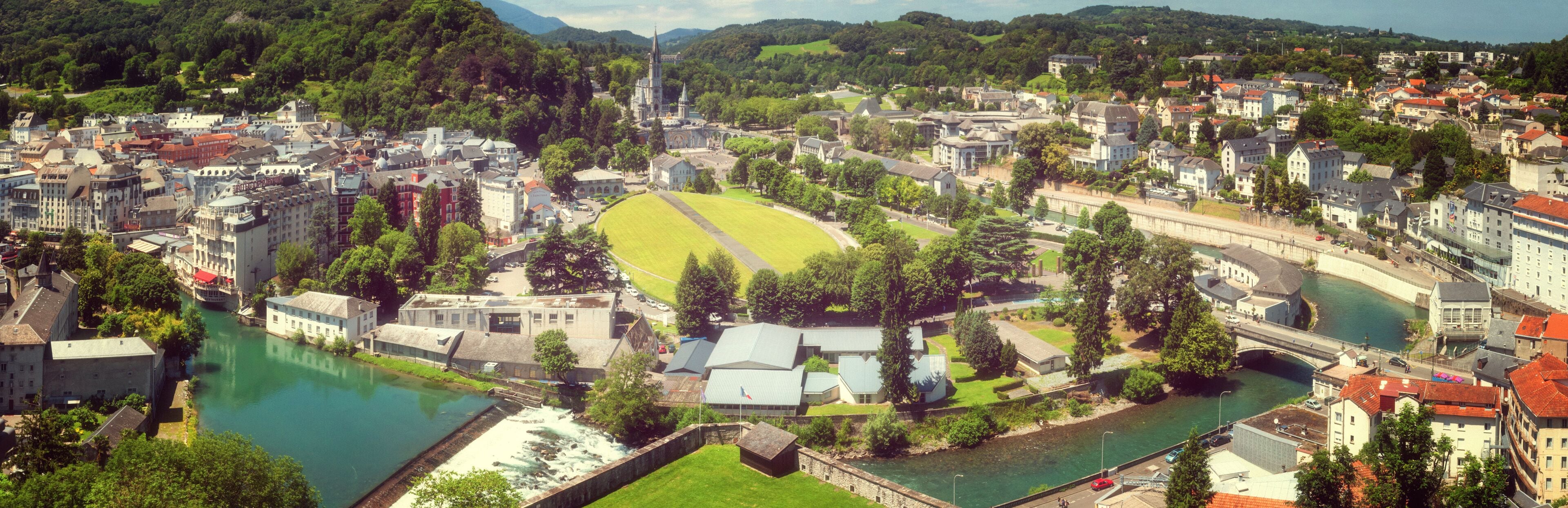 Panoramic view of the city Lourdes - the Sanctuary of Our Lady of Lourdes, the Hautes-Pyrenees department in the Occitanie region in south-western France.