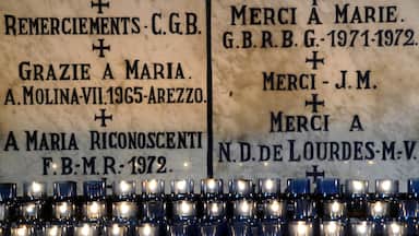 Lourdes which includes signage and interior views