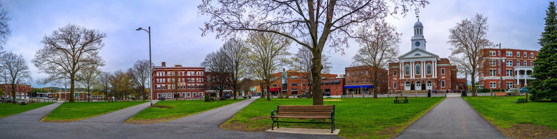 Historic Lebanon City Hall building, downtown skyline, and Colburn Park in Grafton County, western New Hampshire, panoramic spring landscape in rain