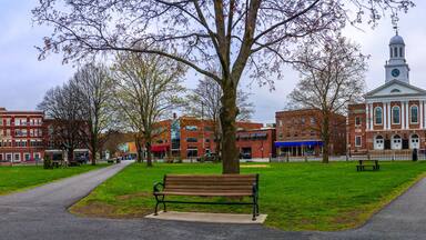Historic Lebanon City Hall building, downtown skyline, and Colburn Park in Grafton County, western New Hampshire, panoramic spring landscape in rain