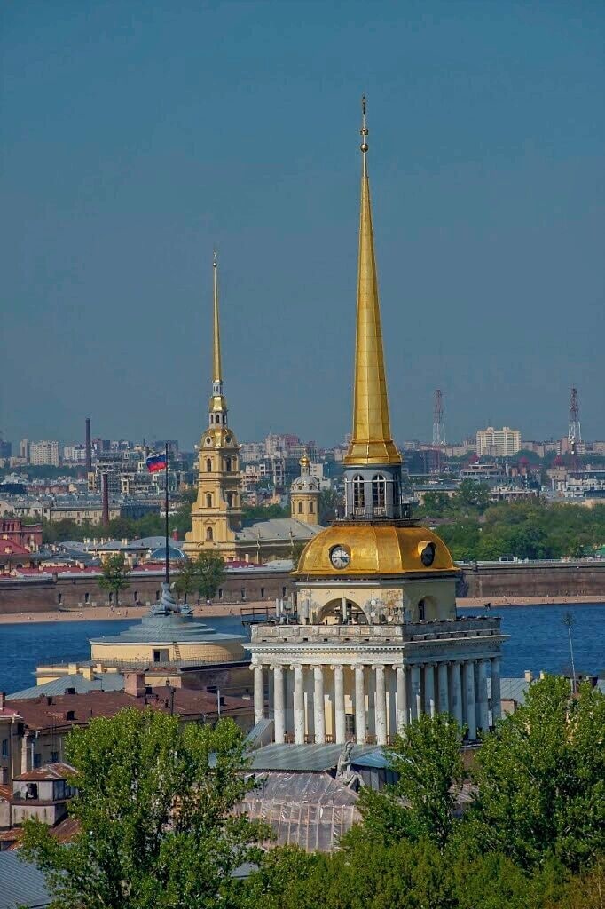 May 2011
Admiralty building, St. Petersburg, Russia 
The dome spires are a trademark of Russian clasicisism architecture. The most famous in St. Petersburg is the tower spire of the Admiralty building from first half of 18th century. It is plated in gold and called the Admiralty needle. The Admiralty was founded in 1704 under the rule of the Tsar Peter the Great and it was the headquarters of the Emperor's Navy as well as the docks. 
Across the Neva river you can see another mighty spire of the Peter and Paul Cathedral on the island with a fortress bearing the same name. 
You can enjoy this view from the rooftop arcade of near St. Isaac's Cathedral.