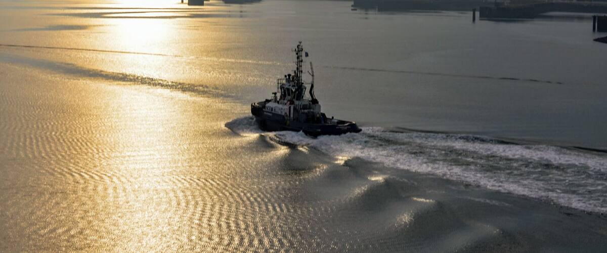 Early morning tug boat in the port area.