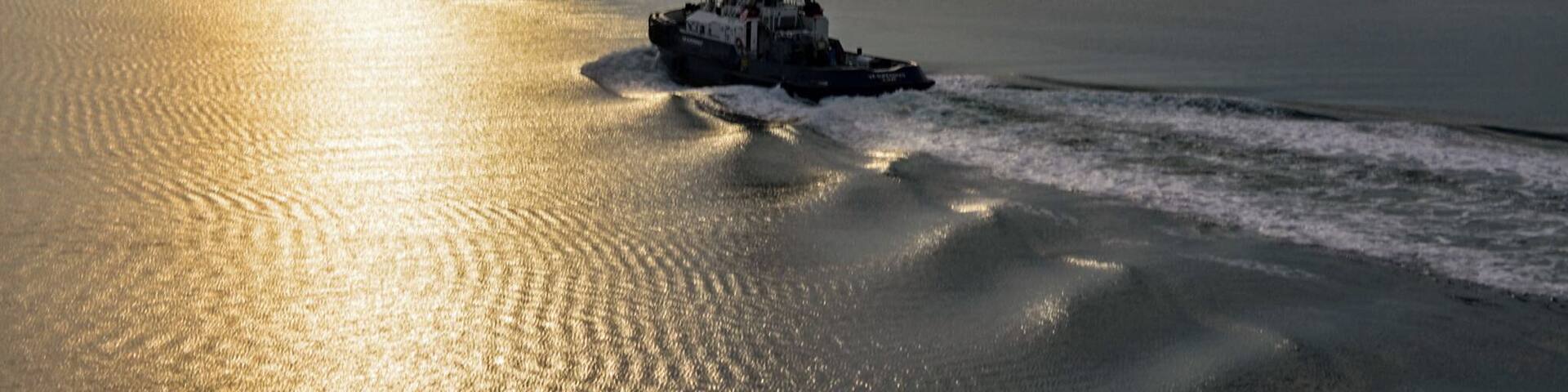 Early morning tug boat in the port area.