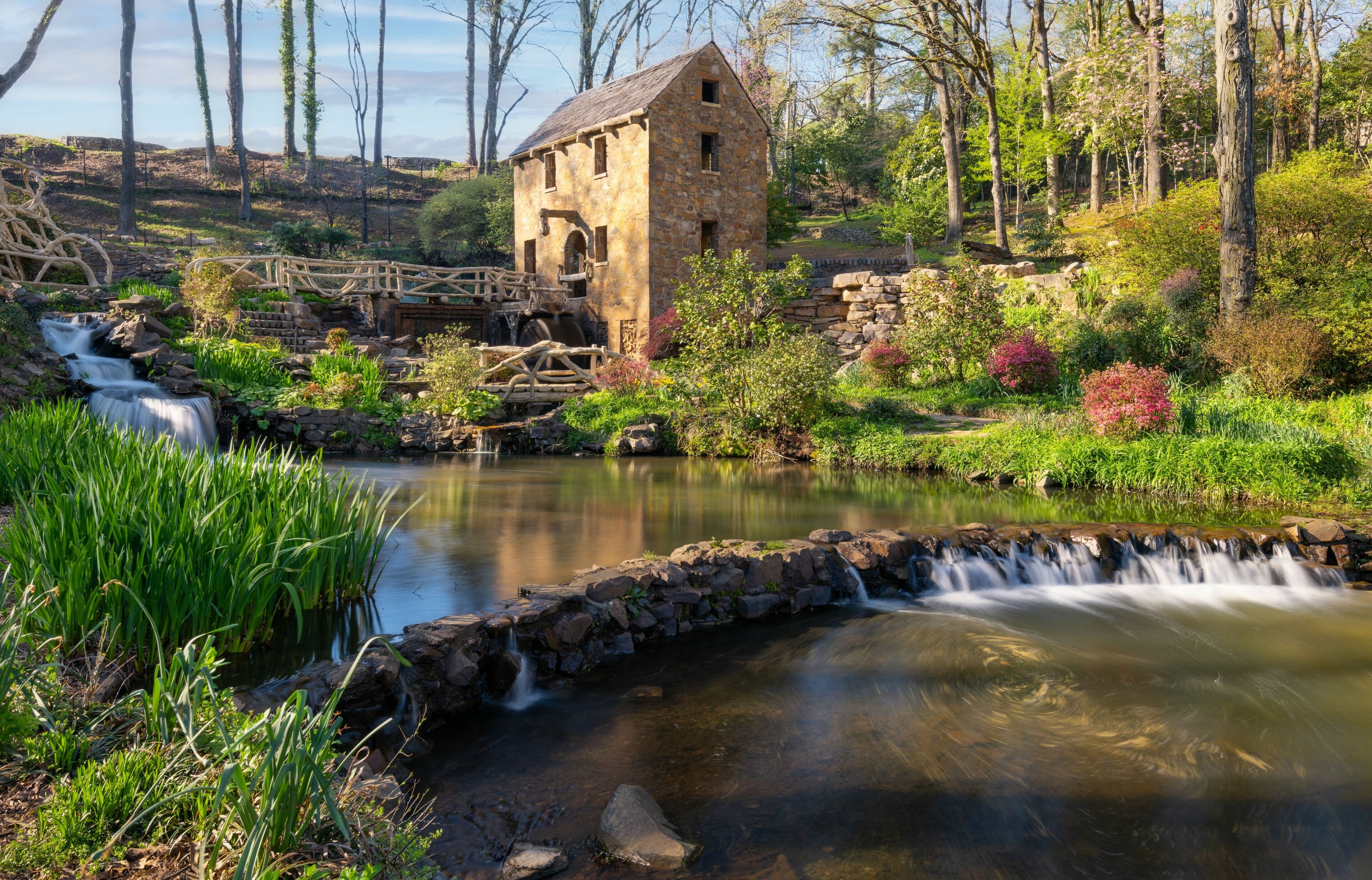 Historical place of Old Mil in Little Rock in Arkansas with flowers and plants near waterfall