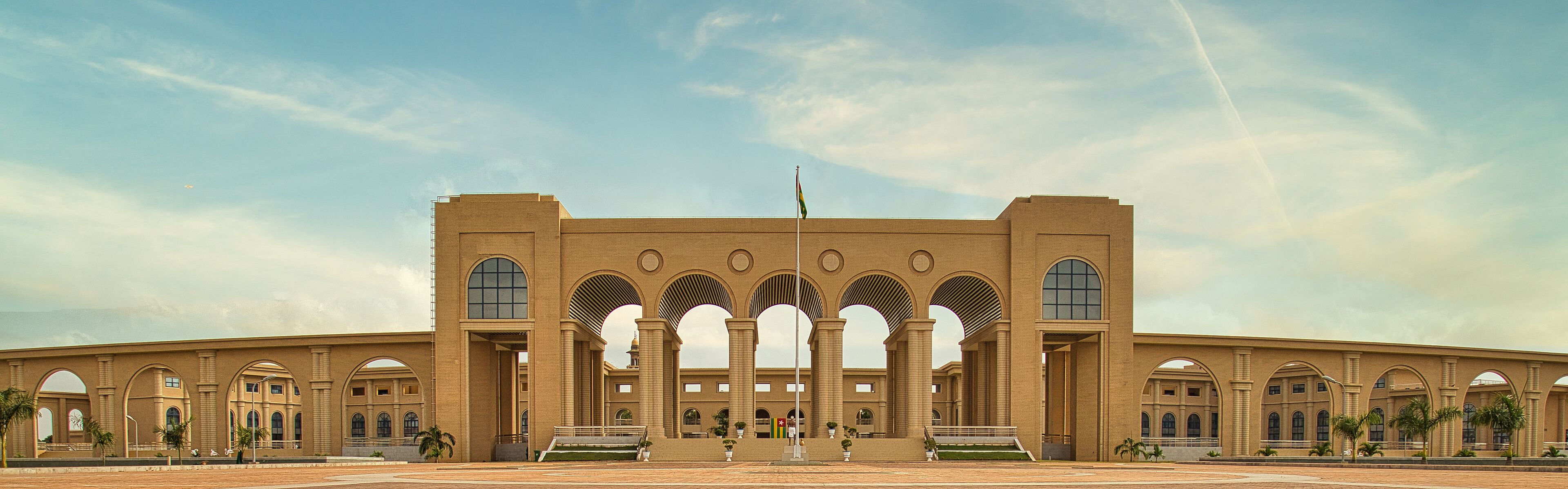 A large, symmetrical building with multiple arched windows and a central entrance.