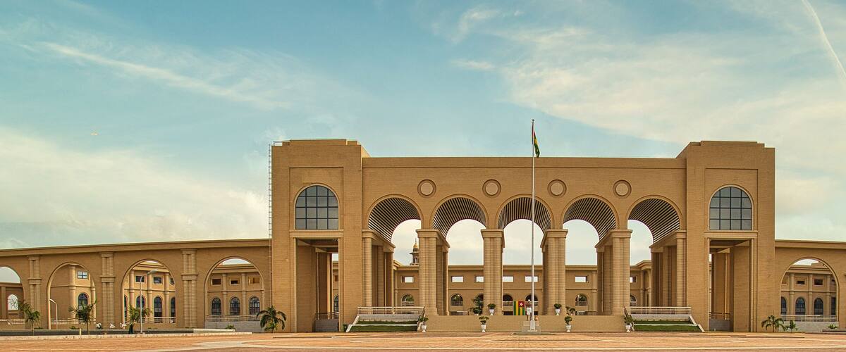 A large, symmetrical building with multiple arched windows and a central entrance.