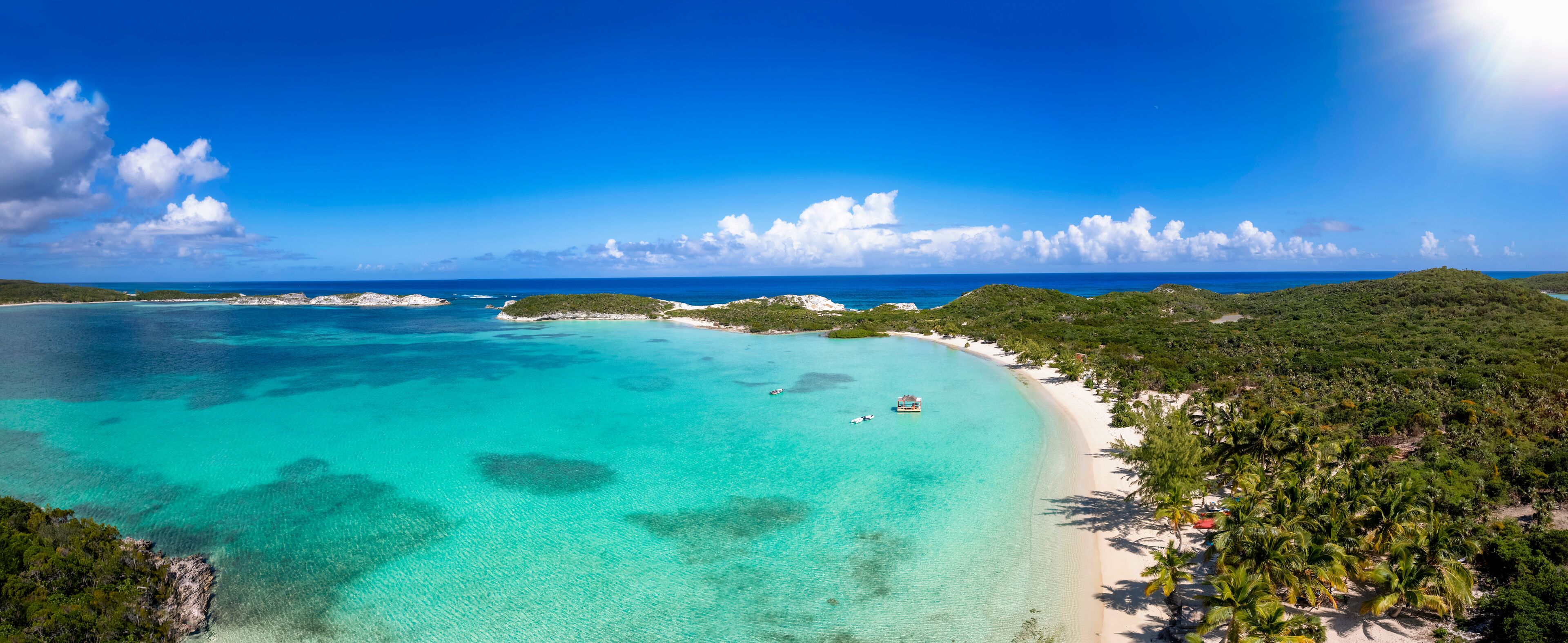 The beautiful Stingray Beach at the north of Long Island, The Bahamas, with tropical palm trees and turquoise sea