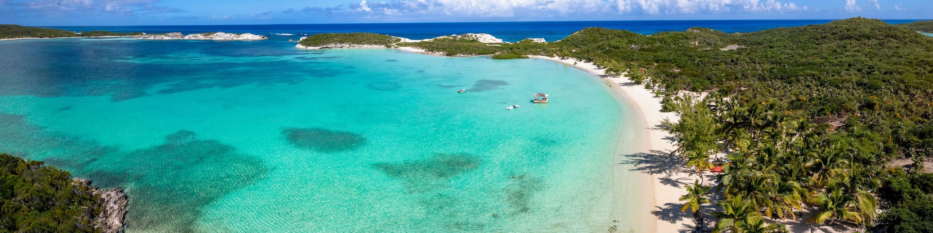 The beautiful Stingray Beach at the north of Long Island, The Bahamas, with tropical palm trees and turquoise sea