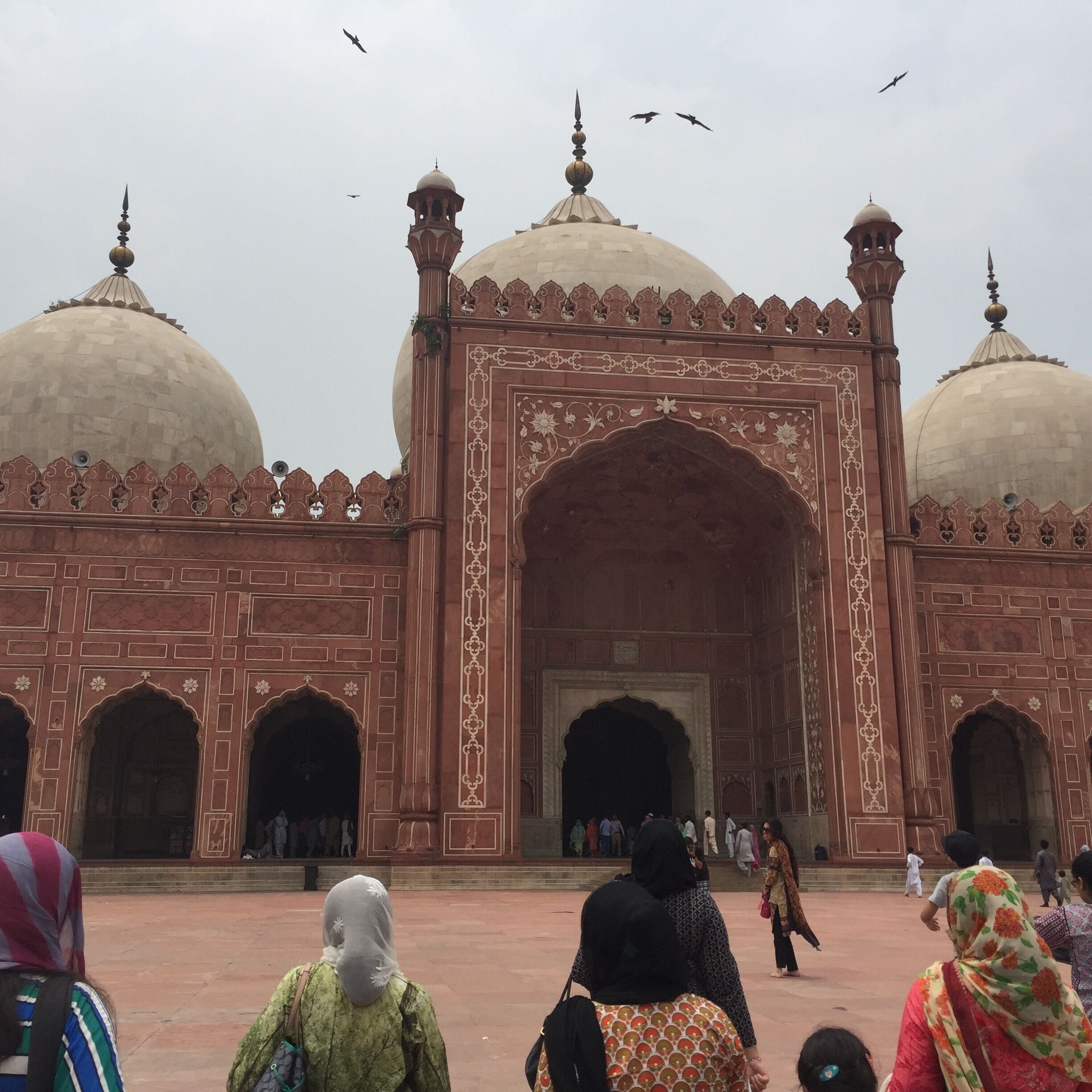 Aurangzeb's mosque's architectural plan is similar to that of his father, Shah Jehan, the Jama Masjid in Delhi; though it is much larger. it also functions as an idgah. The courtyard which spreads over 276,000 square feet, can accommodate one hundred thousand worshippers; ten thousand can be accommodated inside the mosque. The minarets are 196 feet (60 m) tall. The Mosque is one of the most famous Mughal structures, but suffered greatly under the reign of Maharaja Ranjit Singh. In 1993, the Government of Pakistan included the Badshahi Mosque in the tentative list for UNESCO World Heritage Site.