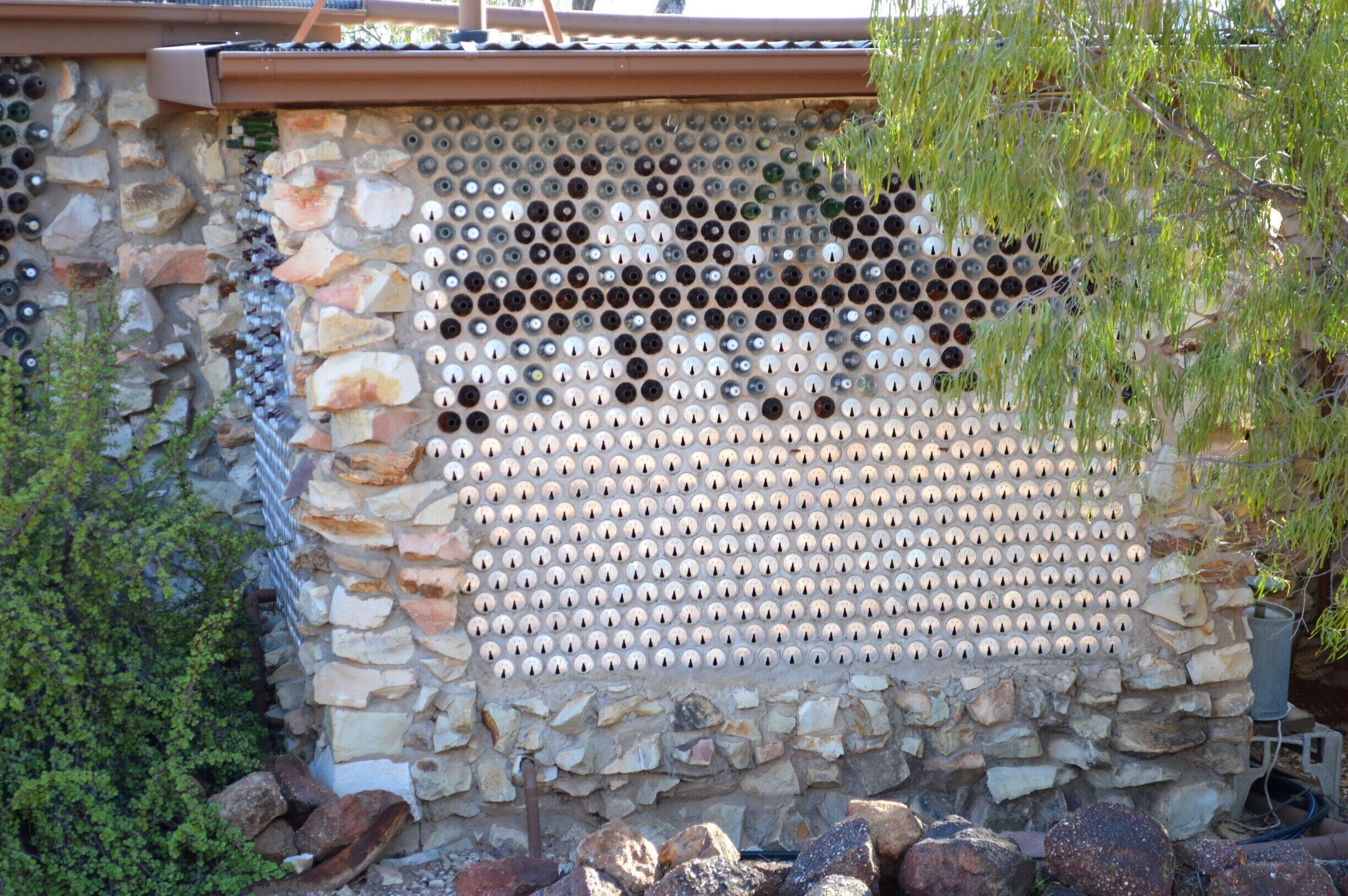 A wall of cans and bottles.  How original.  Only in Lightning Ridge!  
