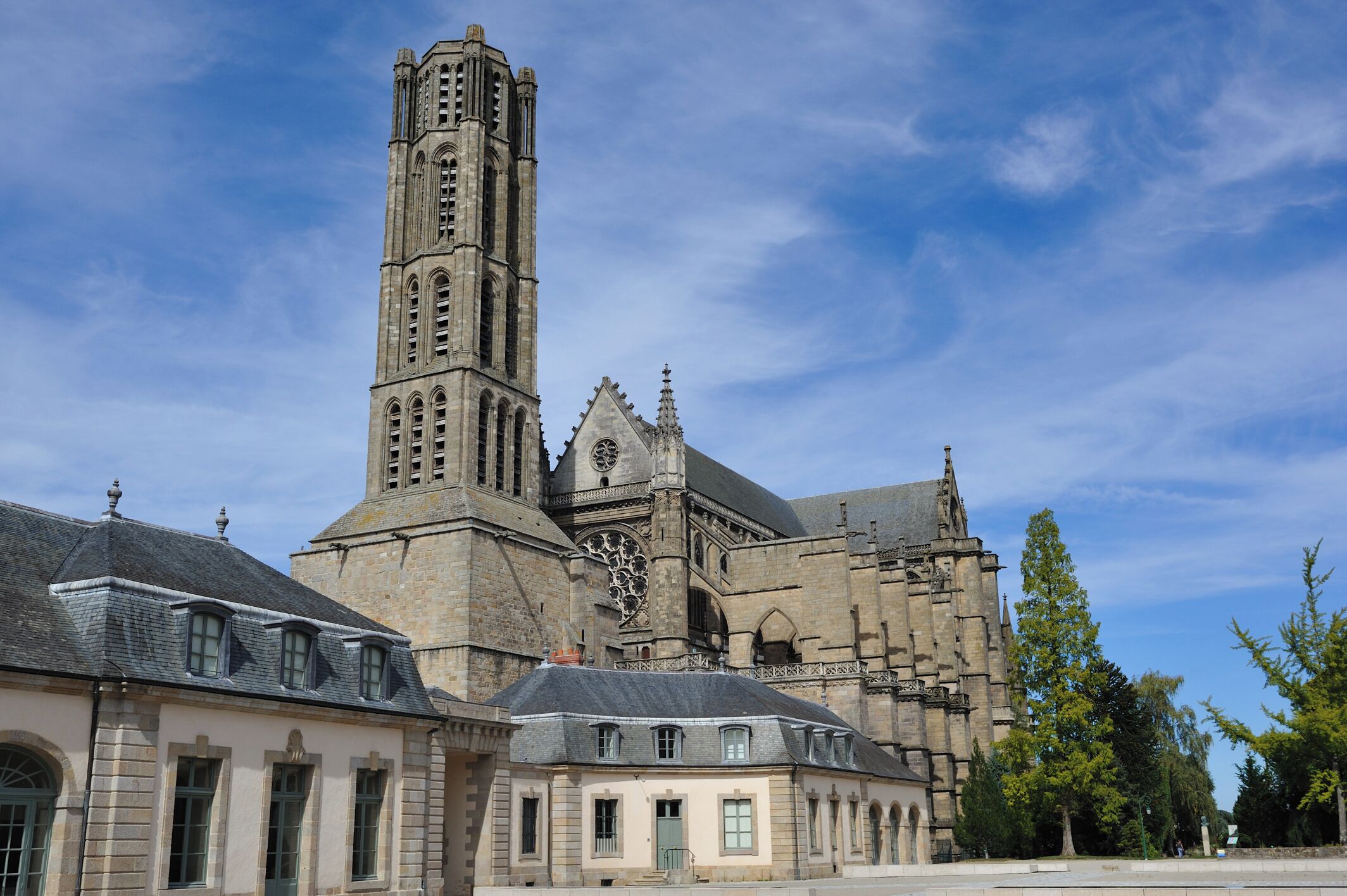 A historic church with a tall bell tower and a large rose window.