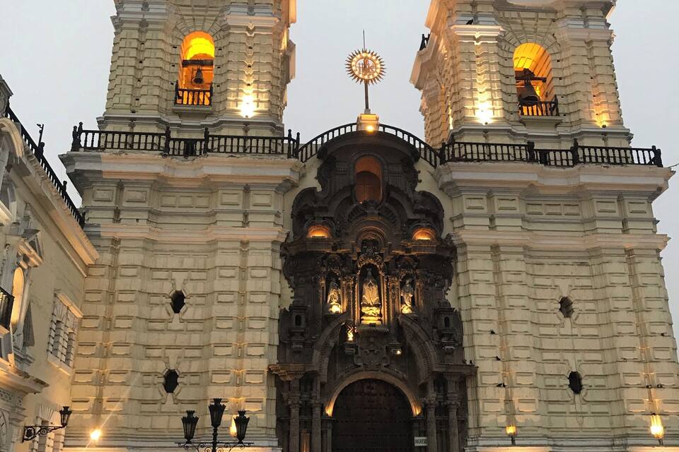 A historic church with two bell towers, ornate arches, and a central dome.