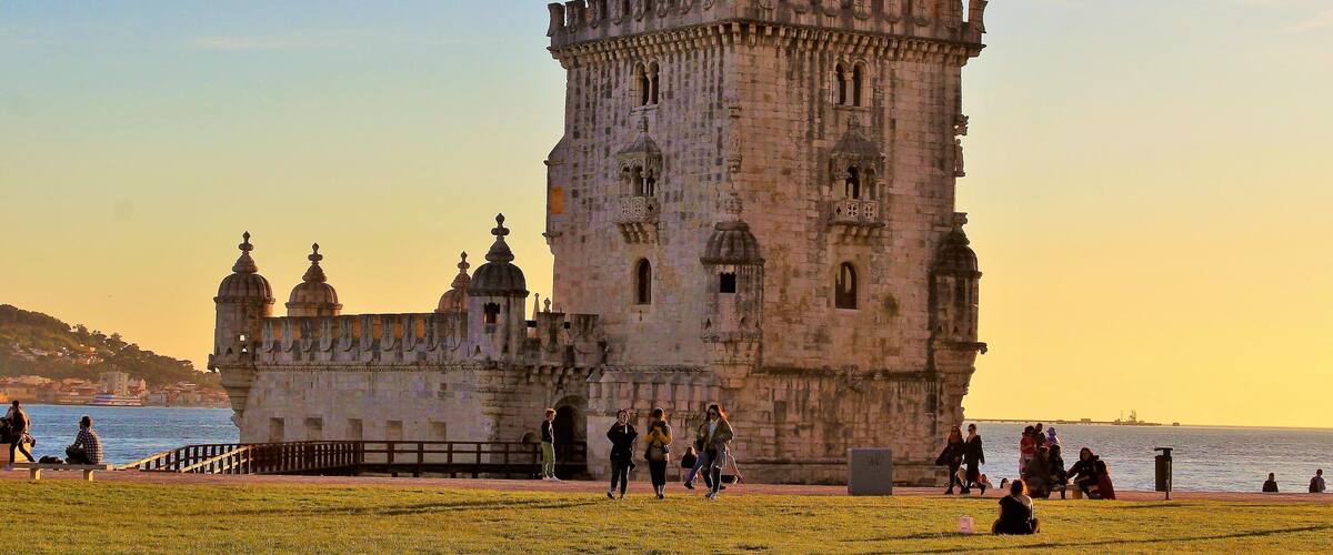 I took this in March at Belém Tower, in Lisbon, Portugal. And came at just the right time - sunset time! And yet there were still quite a few people lazying about :). It was a beautiful Spring day there!
This fortified tower is a UNESCO World Heritage Site and one of the most iconic sites in Lisbon! Built in the early 16th-century, it played a significant role in the Age of Discoveries. The tower was commissioned by King John II to be part of a defense system at the mouth of the Tagus river and a ceremonial gateway to Lisbon. The structure was built from Lioz limestone and is composed of a bastion and a 30 m (98.4 ft),four storey tower. It's impressive to see in person! Thanks to Wikipedia for the info, as well ;).