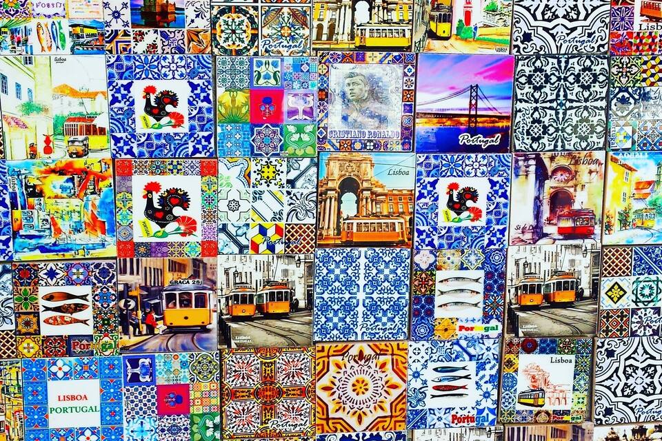 A collage of various tiles and postcards featuring Lisbon, Portugal, including landmarks like the Jerónimos Monastery and trams.