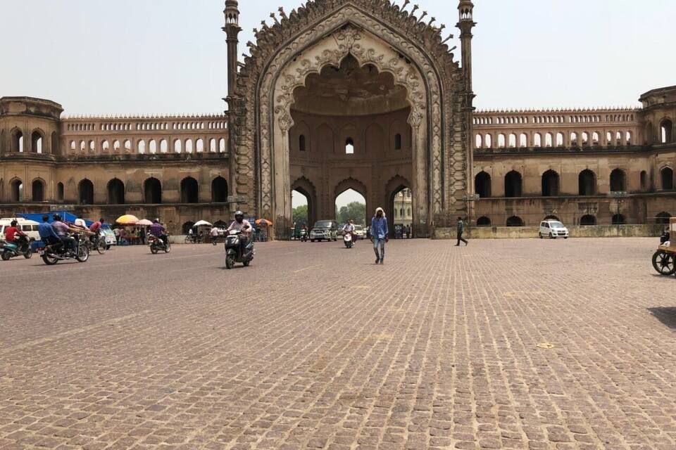 A historic building with an ornate archway and a cobblestone courtyard.