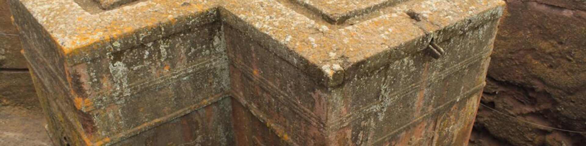 The Church of St. George is one of eleven monolithic churches in Lalibela.
Carved from solid red volcanic rock in the 12th century, it is the most well known and last built of the eleven churches in the Lalibela area, and has been referred to as the “Eighth Wonder of the World”.
Lalibela, King of Ethiopia, sought to recreate Jerusalem, and structured the churches landscape and religious sites in such a way as to achieve such a feat. The churches at Lalibela are clustered in two major groups, one representing the earthly Jerusalem, and the other representing the heavenly Jerusalem. Located directly between them is a trench representing the River Jordan.
#History