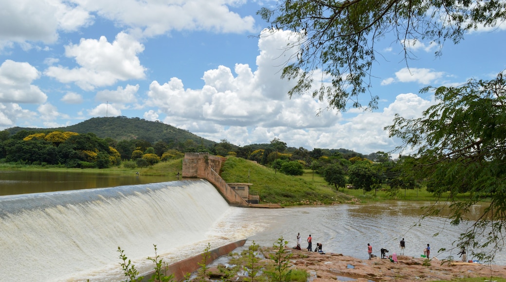 Amazing lanscape with small waterfall. African people are washing clothes near Kamuzu dam in Lilongwe, Malawi - in one of the poorest countries ath the world