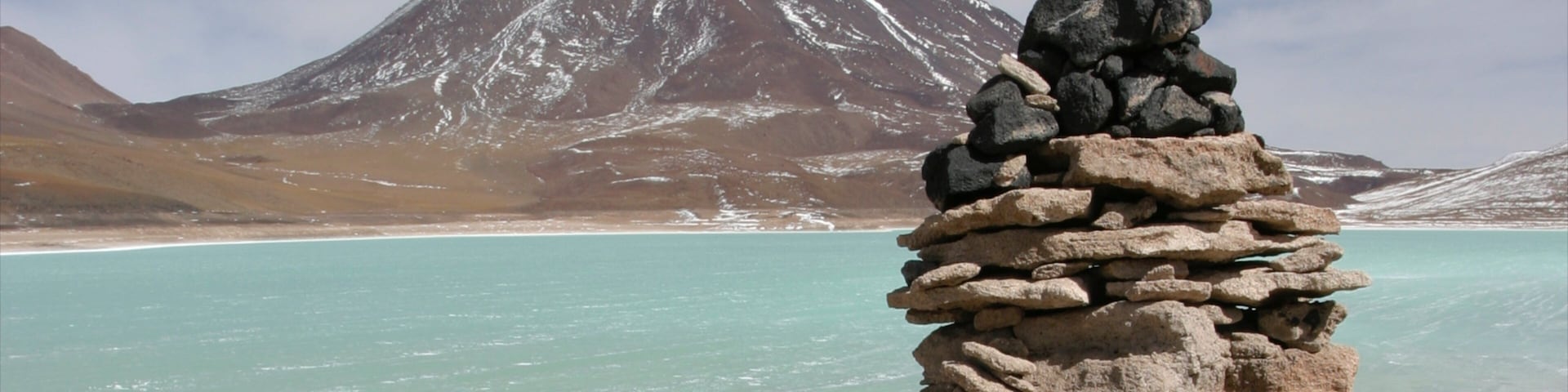 Bolivia featuring snow, a lake or waterhole and mountains