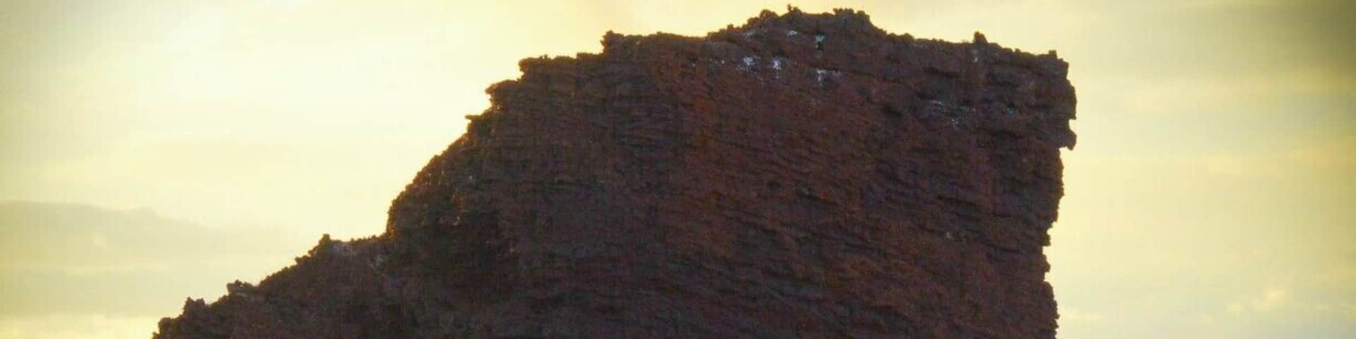 Behold... Puu Pehe, known as âSweetheart Rockâ.
This is Lanaiâs most notable landmark and the setting for one of Hawaiiâs epic legends.
Story goes a hottie princess from Maui was "captured" by a young warrior from Lanai. He made her his wife and he was so smitten with her beauty and... apparently so insecure that he was afraid to let other men see her so kept her in a sea cave near the rock when he was away. One day the weather suddenly changes, the surf slams the area, and... yup, one less princess. The warrior rushed back to the cave, but it was too late, he climbed the steep rock where he buried her in a tomb and then overcome with grief leapt to his death.
Moral of story might be... um, don't abduct women and lock them in caves.