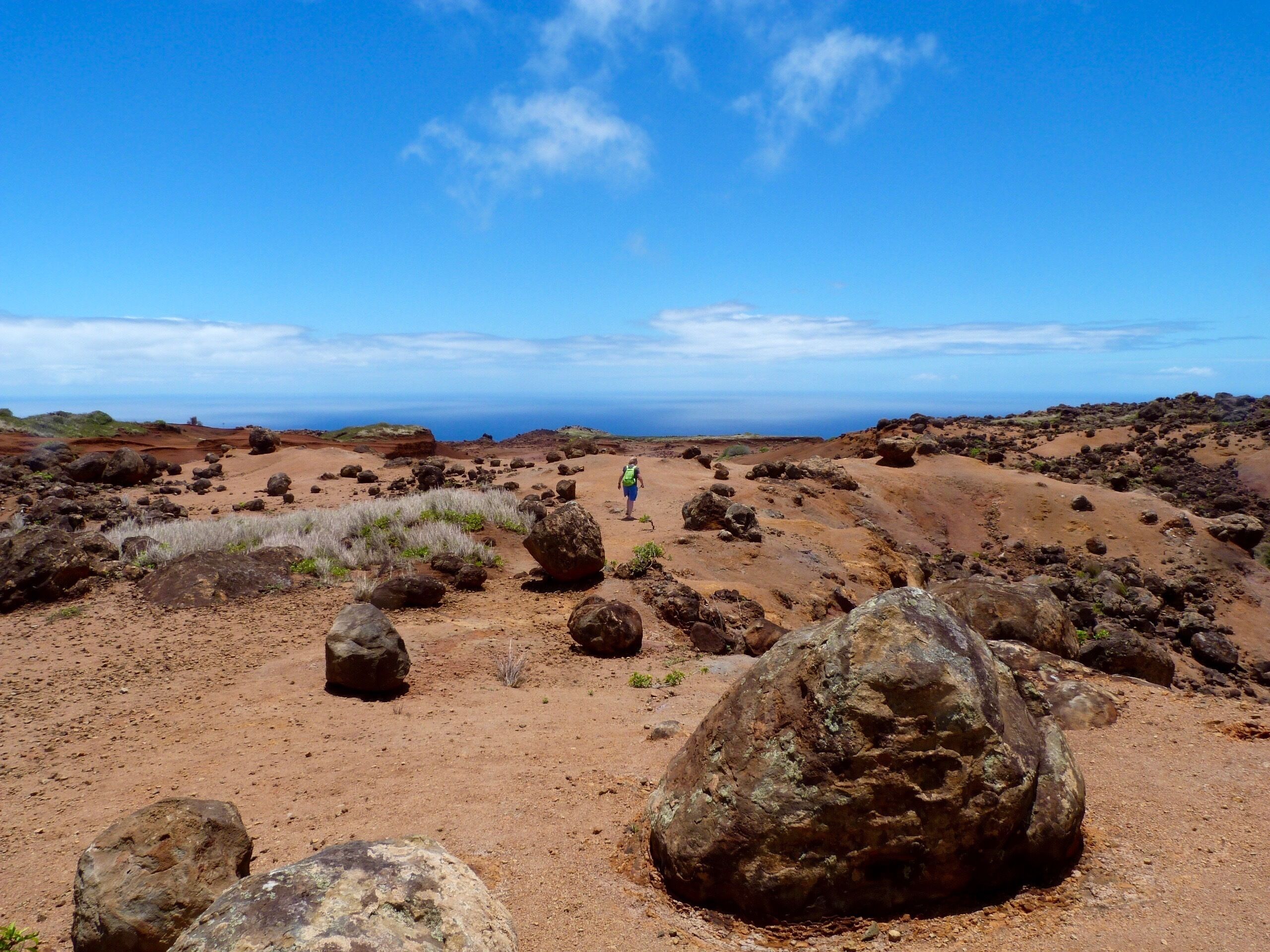 A rocky landscape with large boulders and a clear blue sky.