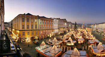 Linz which includes a city, a sunset and a square or plaza