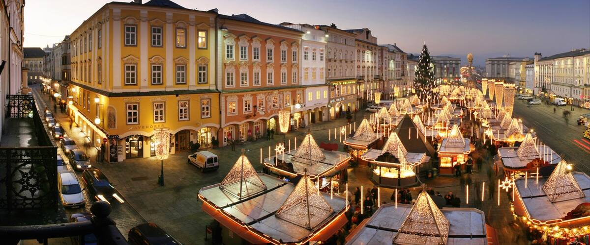 Linz which includes a sunset, a city and a square or plaza