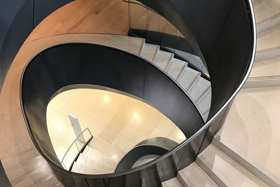 A spiral staircase with a circular design, ascending to a higher floor.