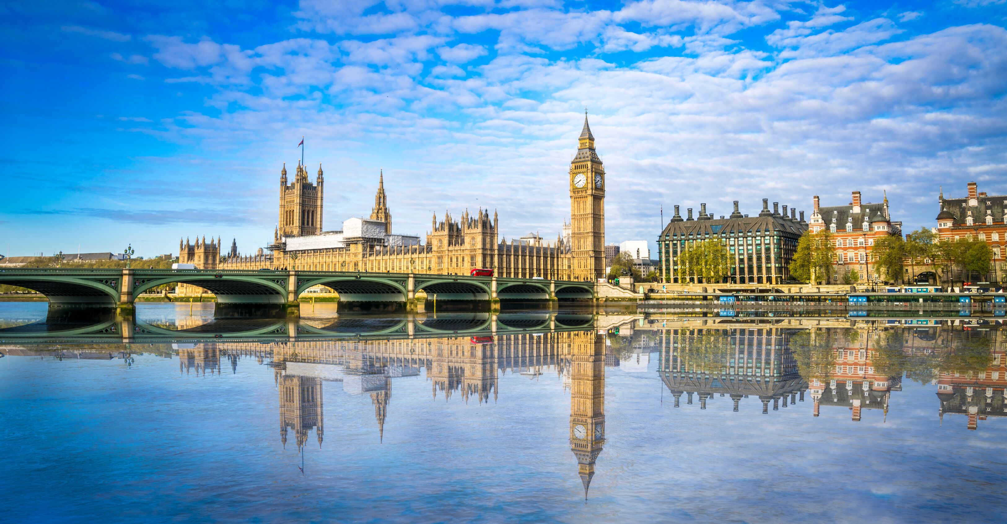 The Houses of Parliament and Big Ben reflected in the River Thames.