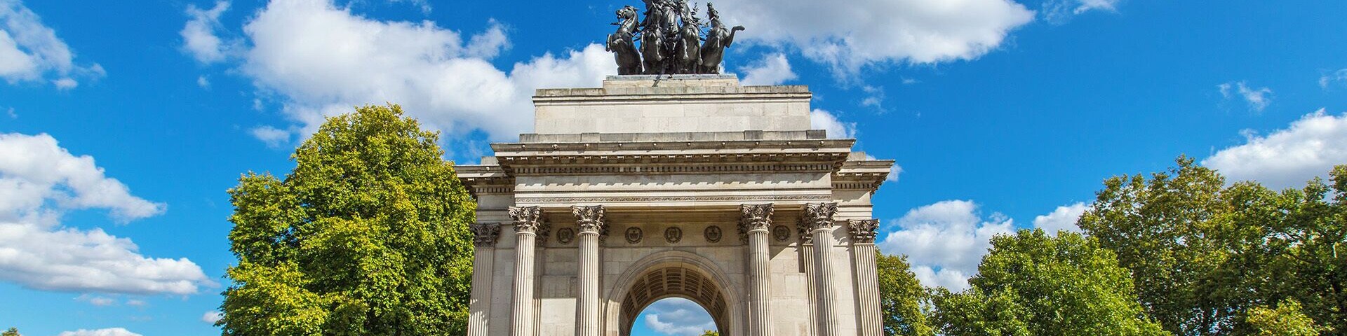 Wellington Arch is a triumphal arch at the center of Hyde Park in central London. It took four years to build and was completed in 1830, though not at the site where it currently stands and not with the statue which currently resides atop. The arch was moved to Hyde Park around 1882-1883 and the original adorning statue was of the 1st Duke of Wellington riding a horse, which gave the arch its name.