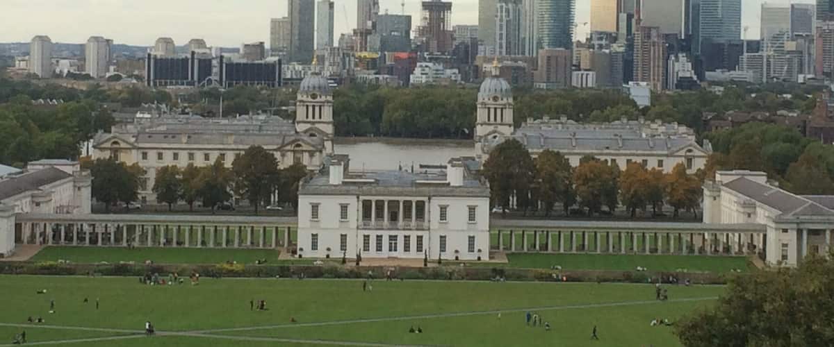 The view across to Canary Wharf from the Royal Observatory at Greenwich. Old Royal Naval college in the foreground.