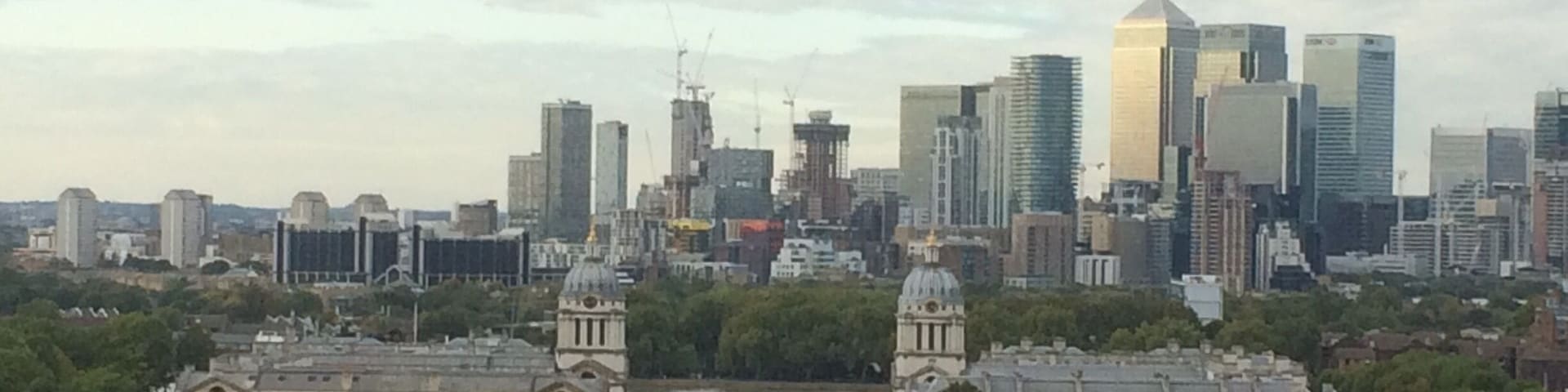 The view across to Canary Wharf from the Royal Observatory at Greenwich. Old Royal Naval college in the foreground.