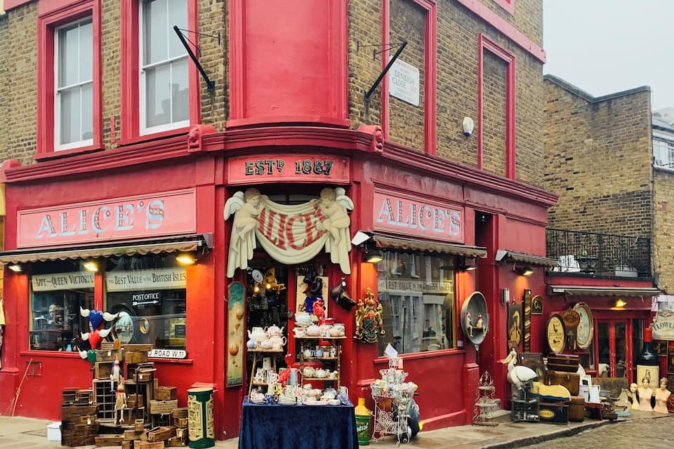 A red building with 'ALICE'S' signage and a 'POST OFFICE' sign.