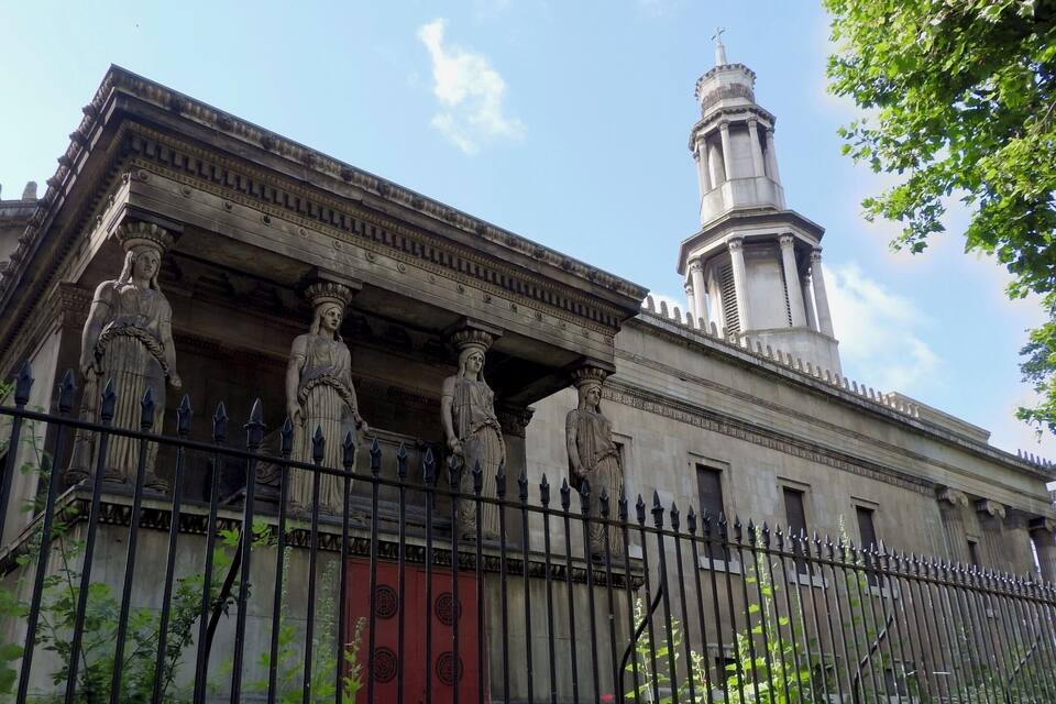 A classical building with columns and a bell tower.