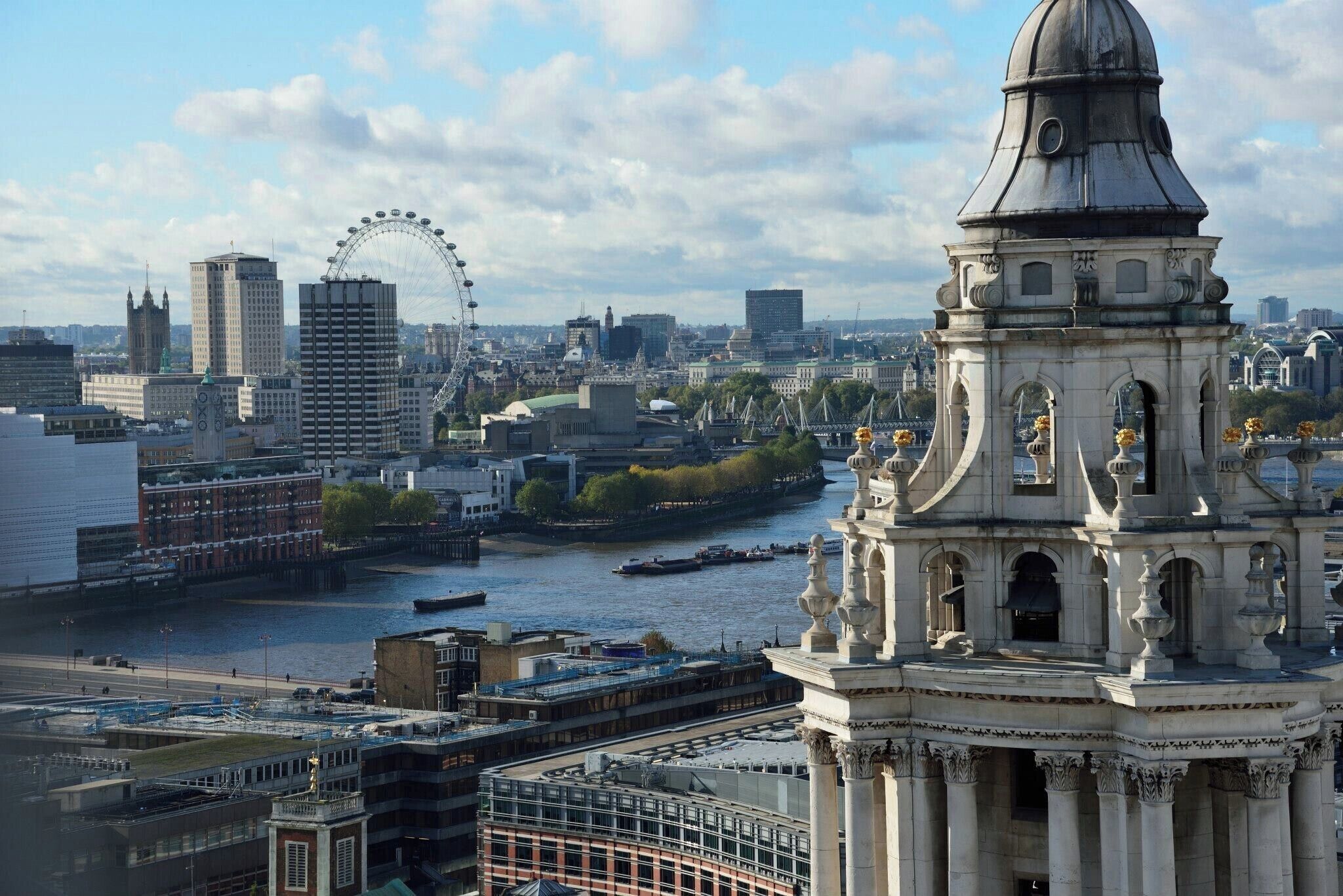 To get this amazing view of London, climb to the Stone Gallery of the St Paul's Cathedral:
The Stone Gallery is the first of two galleries above the Whispering Gallery that encircle the outside of the dome. The Stone Gallery stands at 173 ft (53.4 metres) from ground-level and can be reached by 378 steps. 